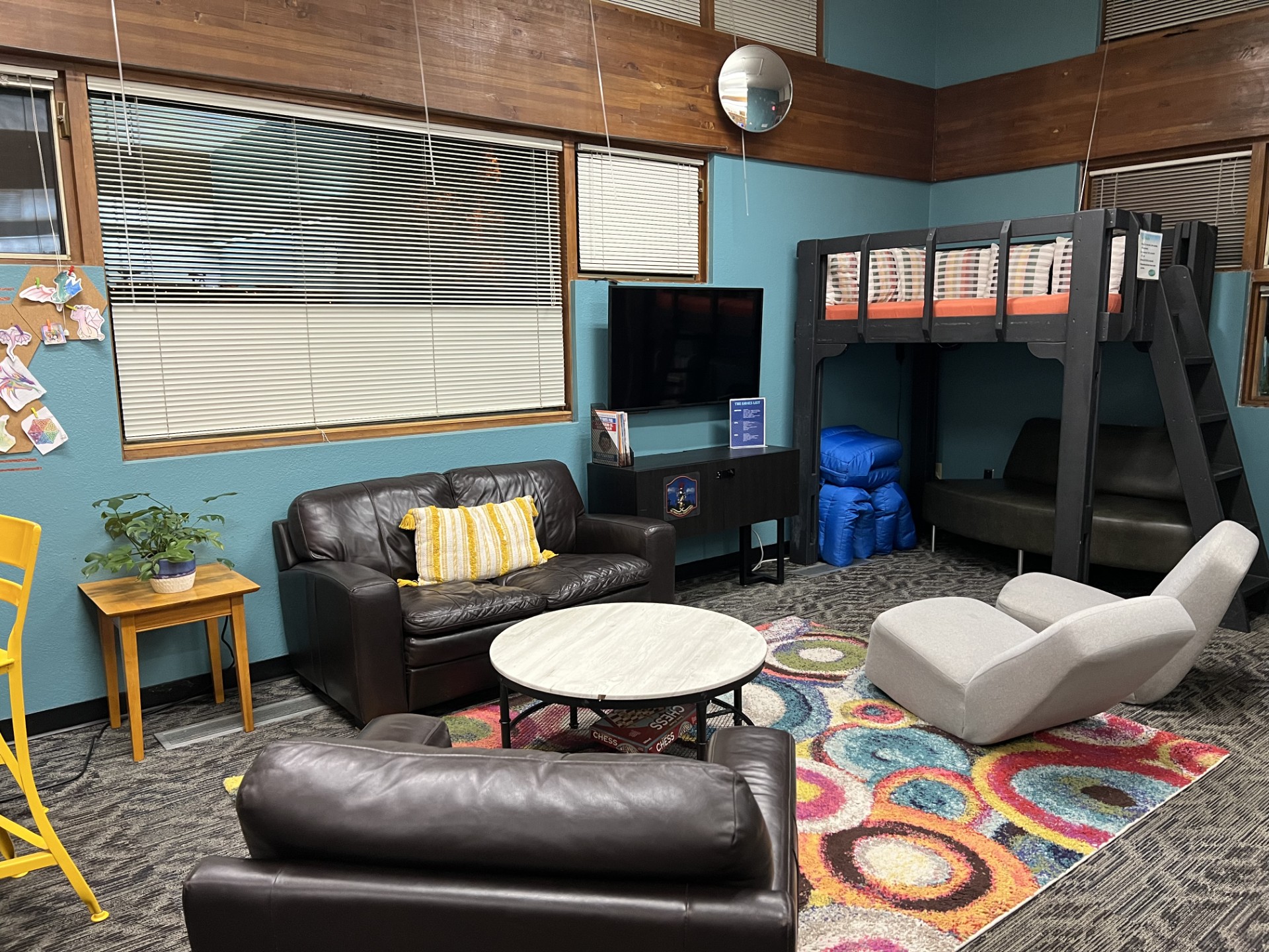 Teen area including couch, chairs and a reading loft