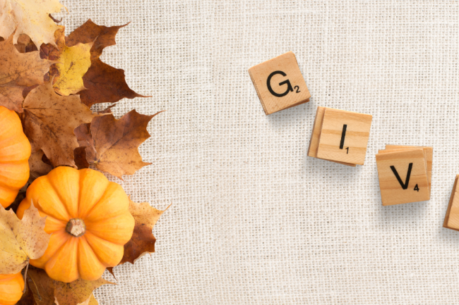 decorative image of pumpkins, leaves, and tiles reading "Give"