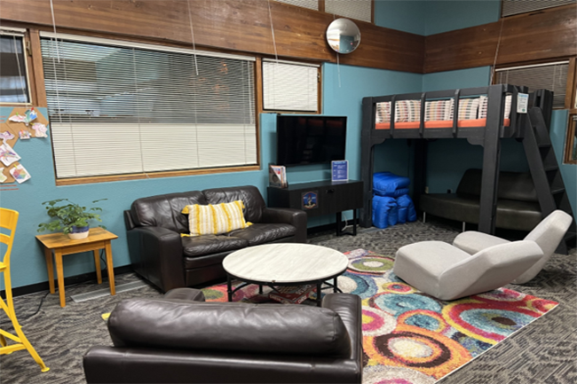 Teen zone featuring couch, chairs and a television for gaming.