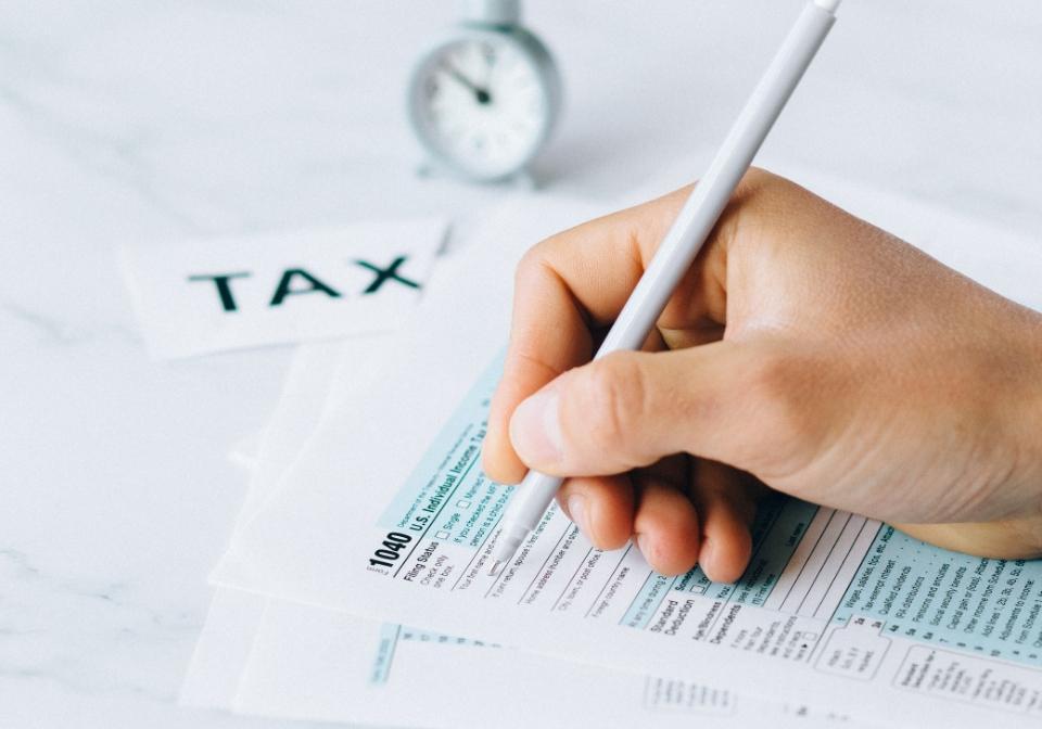 a photo of tax forms being completed by hand